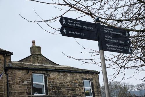 a street sign in front of a brick building at 35A Coach Street in Skipton