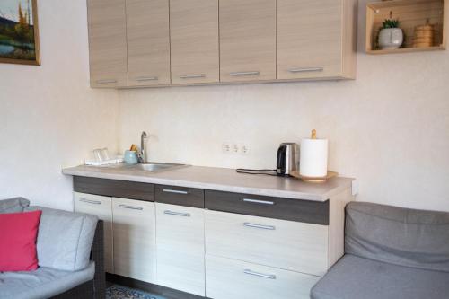 a kitchen with a counter and a sink and a chair at Vähikoja majutus in Kose