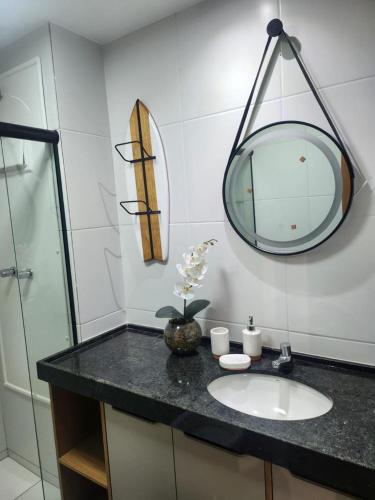 a bathroom with a sink and a mirror at MANA BEACH MURO ALTO - by MB 016 in Porto De Galinhas