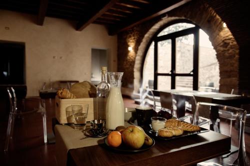 a table with plates of bread and a bottle of milk at Monastero Di Sant'Erasmo in Veroli