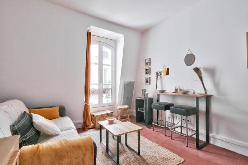 un salon avec un canapé et une table dans l'établissement Lovely Studio Place de la Bastille, à Paris
