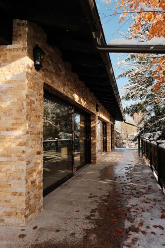 a brick building with a large glass door at Pensiune Agroturistica Molidu in Almaş
