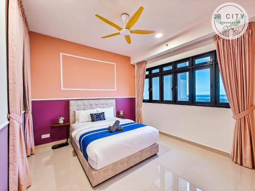 a bedroom with a bed and a ceiling fan at Pangsapuri Meridian by RR JBcity in Nusajaya