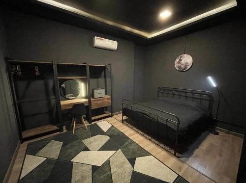 a bedroom with a bed and a tv and a rug at CHUN Hostel in Chiang Mai