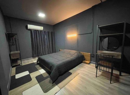 a bedroom with a bed and a mirror on the wall at CHUN Hostel in Chiang Mai