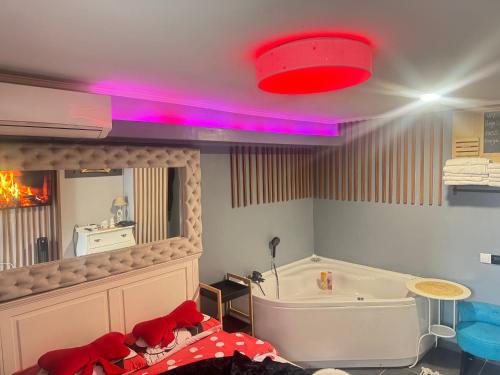 a bathroom with a bath tub and a red light at Apartman Banja Luka CITY in Banja Luka