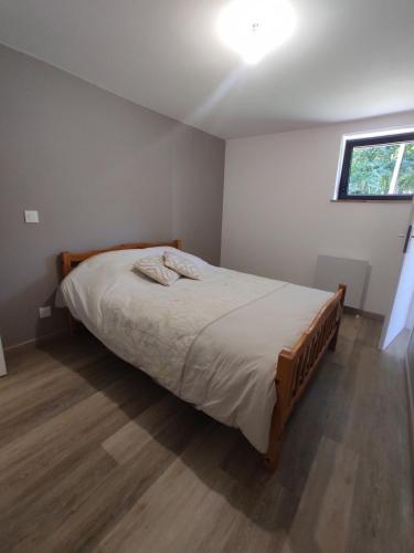 a bedroom with a bed in a room with a window at Garden level apartment in Le Pertuis