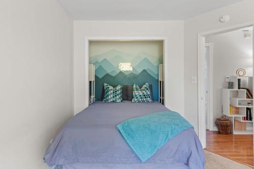 a bedroom with a large bed with blue sheets at Simply Shores by AvantStay Private Beach Dock Lake Overlook in Long Pond