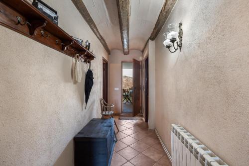 a hallway with a stairway with a ceiling and a room at Cal Cabrer in Sant Jaume dels Domenys
