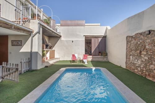 a swimming pool in the backyard of a house at Cal Cabrer in Sant Jaume dels Domenys