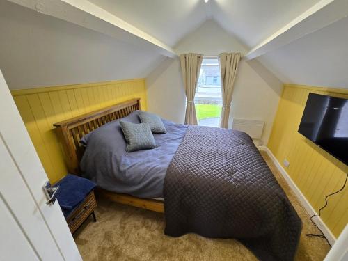a bedroom with a bed with pillows on it at Gower Fresh Christmas Trees in Penclawdd