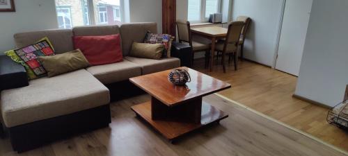 a living room with a couch and a table at Tehnika 7 street apartments in Tallinn