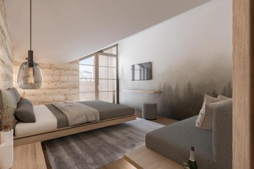 a bedroom with a bed and a tv on the wall at Berghotel Wald & Wiesn in Balderschwang