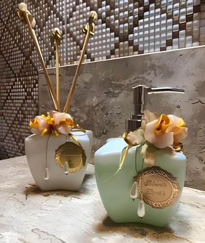 two vases with flowers on them sitting on a table at Cardeiro Flat in São Miguel do Gostoso