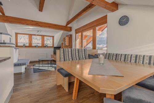 a kitchen and dining room with a wooden table and chairs at Ferienhaus Tirol im Ötztal in Umhausen