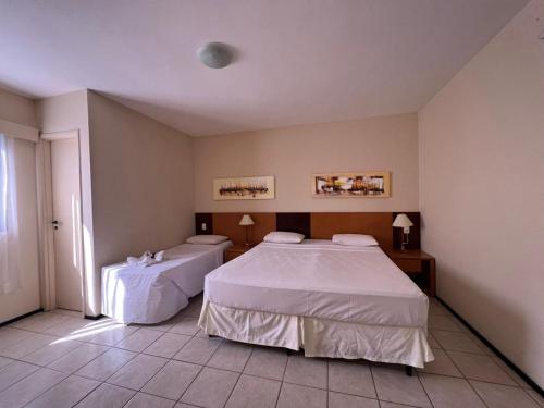 Giường trong phòng chung tại Aquaville Resort Piscinas Praia 2