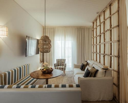 a living room with a couch and a table at AlmaLusa Comporta in Comporta