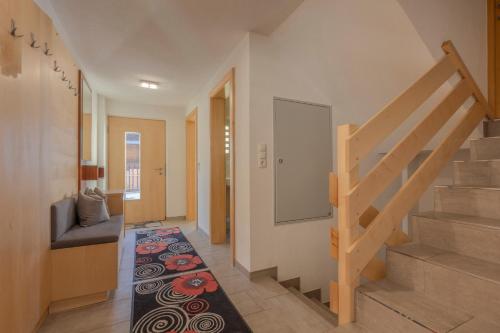 a hallway with a staircase and a rug at Ferienhaus Tirol im Ötztal in Umhausen