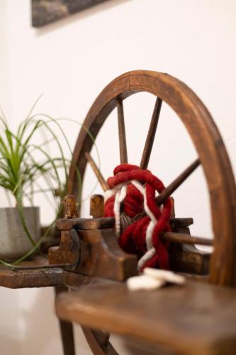 a wooden wheel with a red rope on it at Ferienhaus Tirol im Ötztal in Umhausen