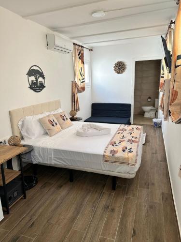 a bedroom with a bed and a wooden floor at Vilador Barcelona Beach Hotel in Masnou