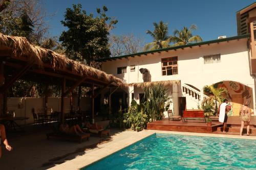 a man standing next to a house with a swimming pool at ESO Santa Teresa in Santa Teresa Beach