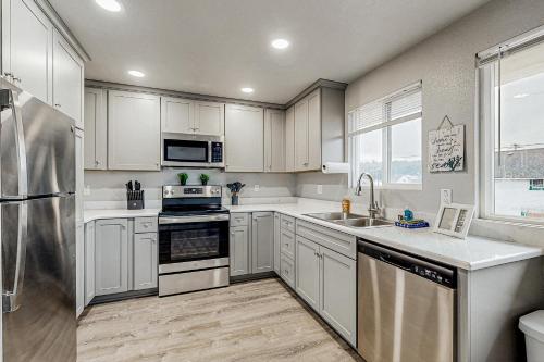 a kitchen with white cabinets and stainless steel appliances at The Sea Horse Suite in Florence