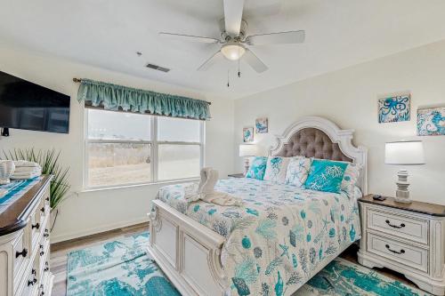 a bedroom with a bed with a ceiling fan and a window at Bethany Bay --- 37460 Pettinaro Dr #6801 in Ocean View