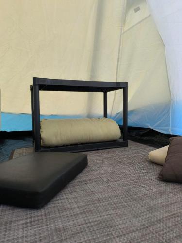 a couch and a pillow in a room with a tent at OM B&B + Spa in Viamão