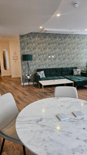 a living room with a couch and a table and chairs at Royal Apartments Bournemouth in Bournemouth