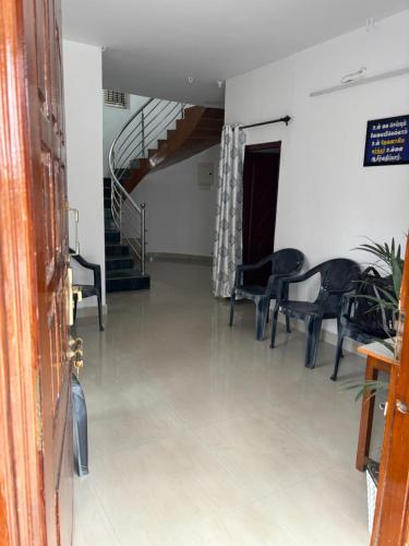 a hallway with chairs and a spiral staircase in a building at Crown Crest in Ooty