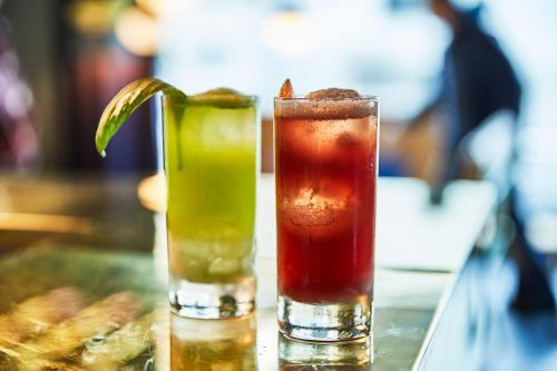 two cocktails sitting on a table with at 25hours Hotel Langstrasse in Zürich