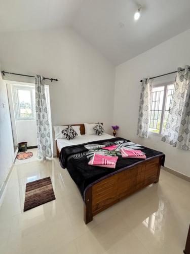a bedroom with a large bed in a room at Crown Crest in Ooty