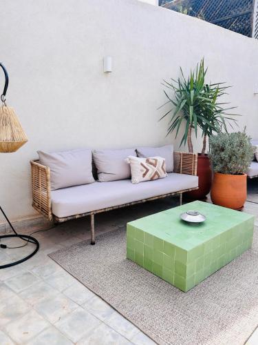 a couch and a coffee table on a patio at Riad Villa Wengé & Spa in Marrakech