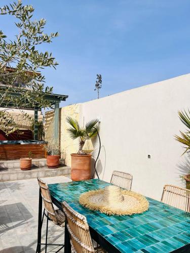 a blue table with chairs on a patio at Riad Villa Wengé & Spa in Marrakech