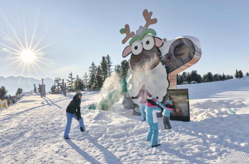 a group of people standing in the snow next to a moose statue at Ferienhaus Tirol im Ötztal in Umhausen