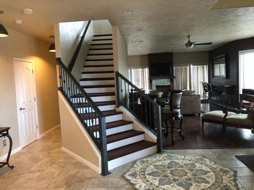 a staircase leading to a living room and a dining room at KOKOPELLI Hideout in Loma