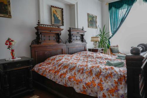 a bedroom with a large bed with a floral bedspread at Zamek Usobi in Úsobí