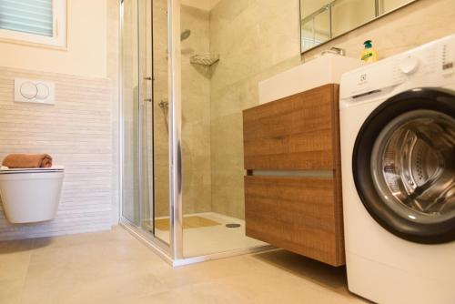 a washing machine in a bathroom with a shower at Villa Mária Marta in Mirce