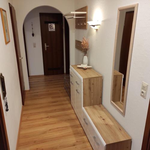 a hallway with a dresser and a mirror in a room at Säckingen 86 qm 3 Zimmer in Bad Säckingen