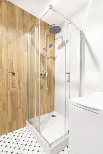 a shower with a glass enclosure in a bathroom at Old Town CityStay Rynek in Wrocław