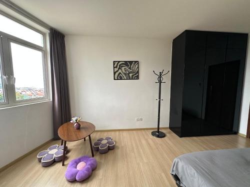 a bedroom with a bed and a table with purple pillows at Joyful Seaview Studio 118 Island88 for 3pax in George Town