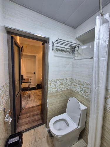 a bathroom with a toilet in a room at YASMIN in Samarkand