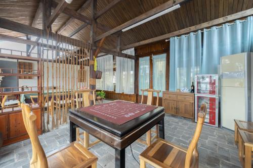 a dining room with a wooden table and chairs at 云海酒店 in Zhangjiajie