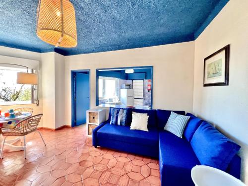 a blue couch in a living room with a table at Lagos Ocean Breeze 2 by Homing in Lagos