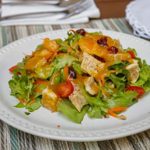 a salad on a white plate on a table at Mandarina's House Hotel in Tuxtla Gutiérrez