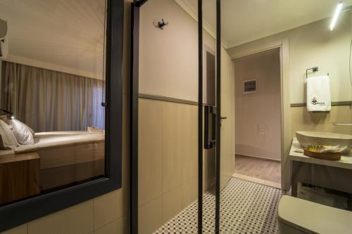 a bathroom with a shower and a sink and a toilet at Ansira Fethiye in Fethiye