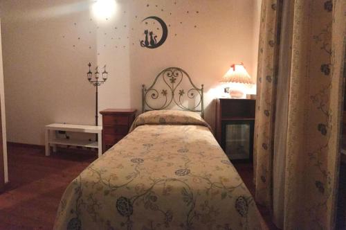 a bedroom with a bed and a table and a lamp at Agriturismo Corte Marani in Badia Calavena