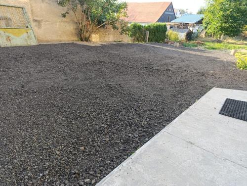 a gravel driveway with a lot of dirt and a building at Ubytování Stráž in Stráž