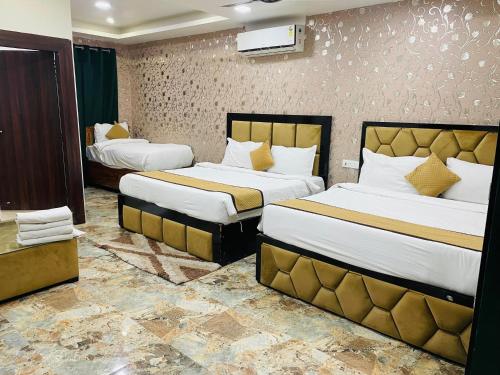 a hotel room with two beds in a room at The Tulsi Garden - Ashram vihar vrindavan in Vrindāvan