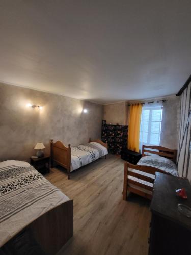 a hotel room with two beds and a window at Gîte Chez Angela in Bar-sur-Aube